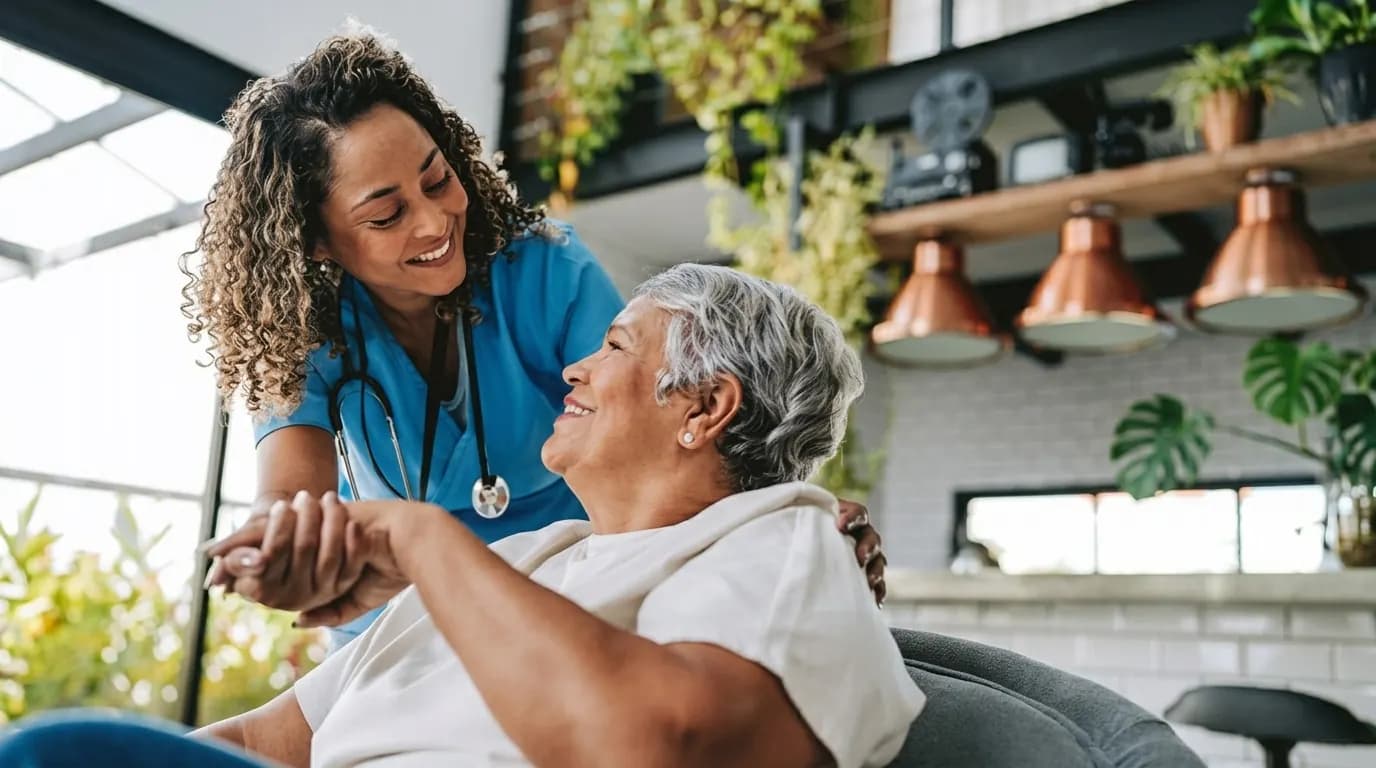 A caregiver sharing a warm moment with an older woman at home